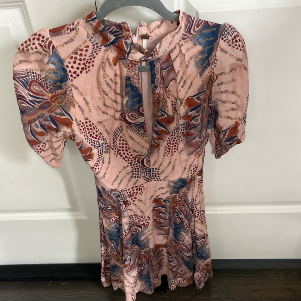 Free people romper, super unique has a key hole opening in the front!